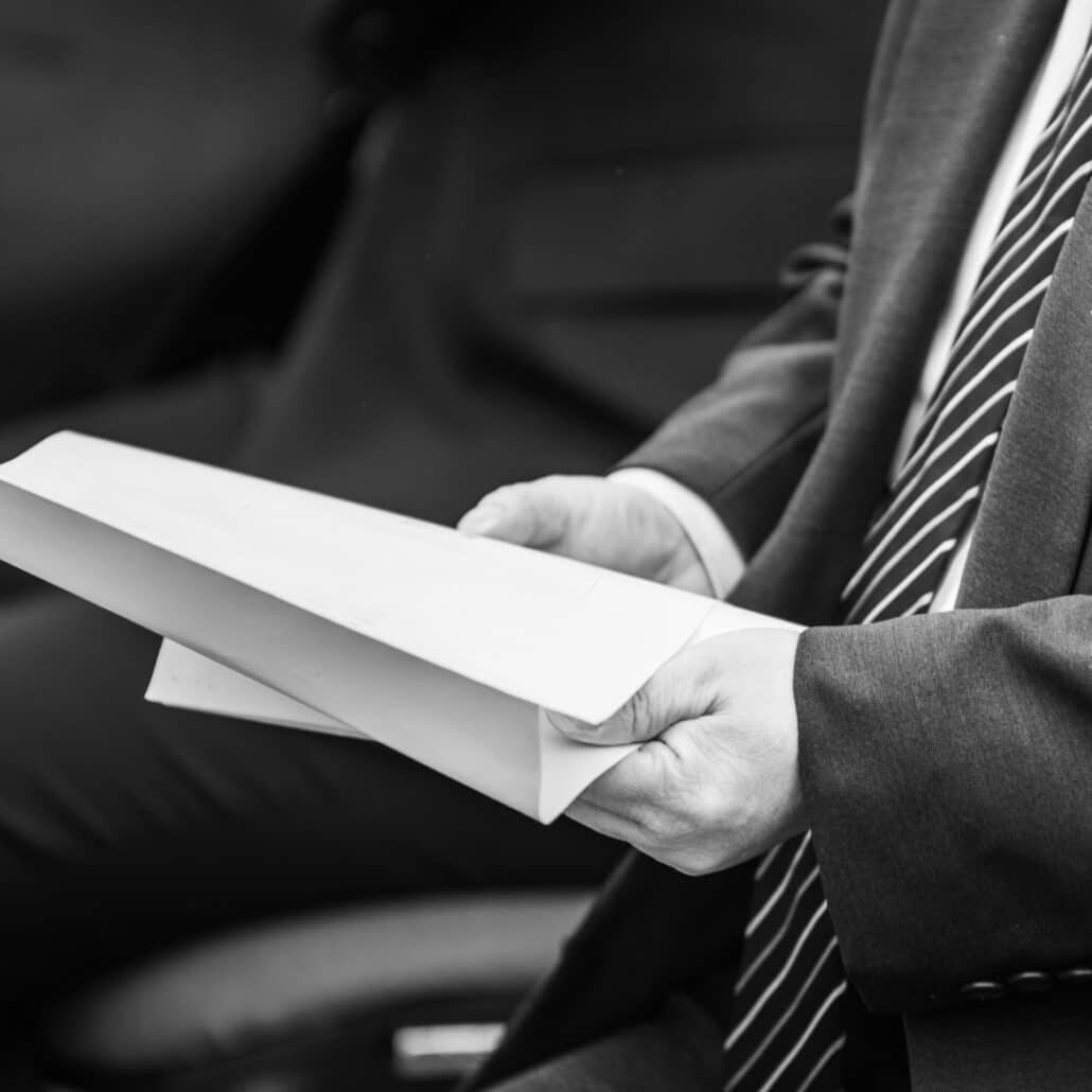 Corporate man holding white paper